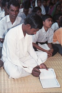 Pastor A. David takes notes